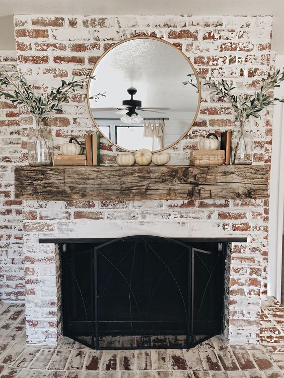 German schmear fireplace with large mantel, mirror, and farmhouse decor