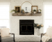 limewashed brick fireplace with mirror and farmhouse decor